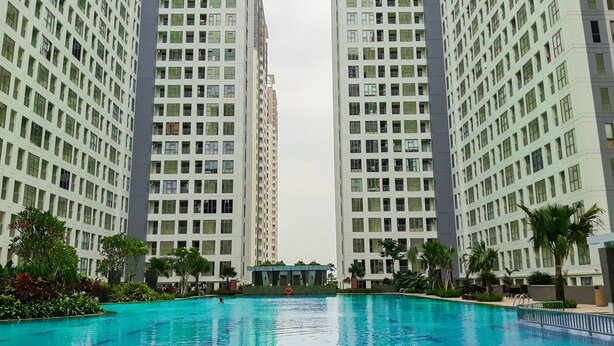 Una piscina rodeada de edificios residenciales altos.