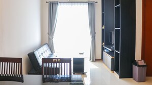 A modern living room with a sofa, a coffee table, and a TV stand. - Full Furnished With Comfort Design 2Br Apartment At Thamrin Residence (Jakarta)