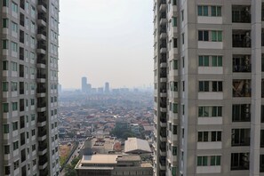 A high-rise building with multiple floors, large windows, and balconies.