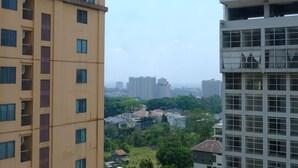 A high-rise building with multiple floors, large windows, and balconies. - Scenic 2Br At Grand Setiabudi Apartment (Bandung)