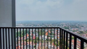 A balcony with a view of a cityscape.