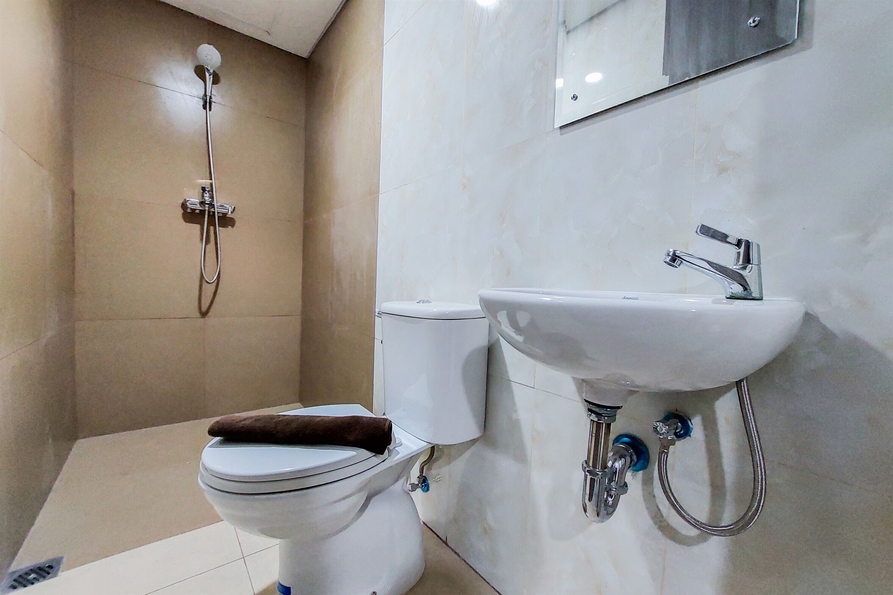A bathroom with a toilet, a sink, and a shower.