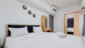 A neatly made bed with white linens, a wooden headboard, and a nightstand with a mirror.