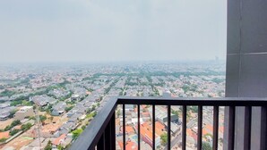 A balcony with a view of a residential area.