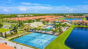 A resort with multiple swimming pools, a large central pool, and a lake. - Lakeview Resort Home, Private Pool, Gym, Game Room (Kissimmee)
