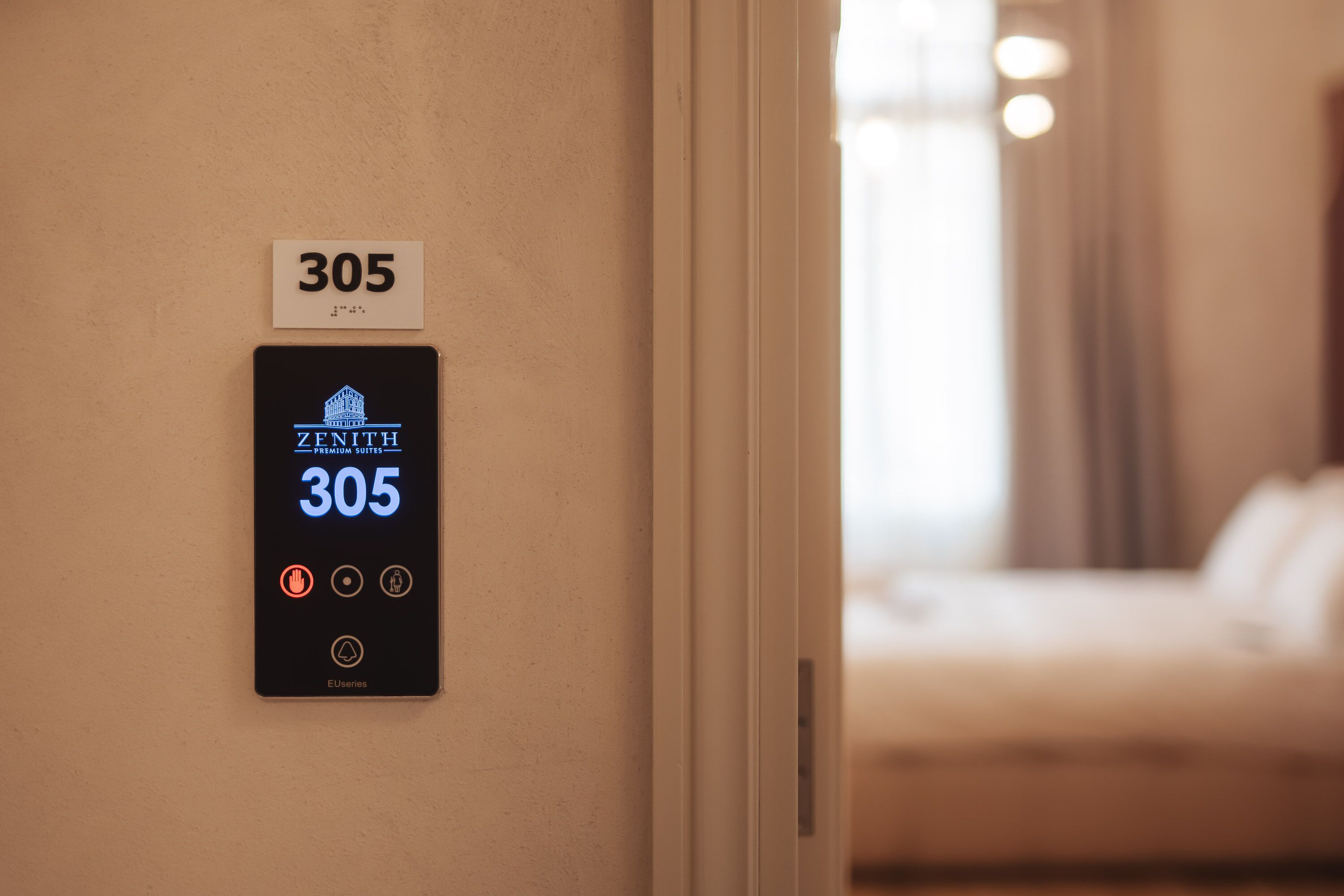 A hotel room number sign and a digital keycard display.
