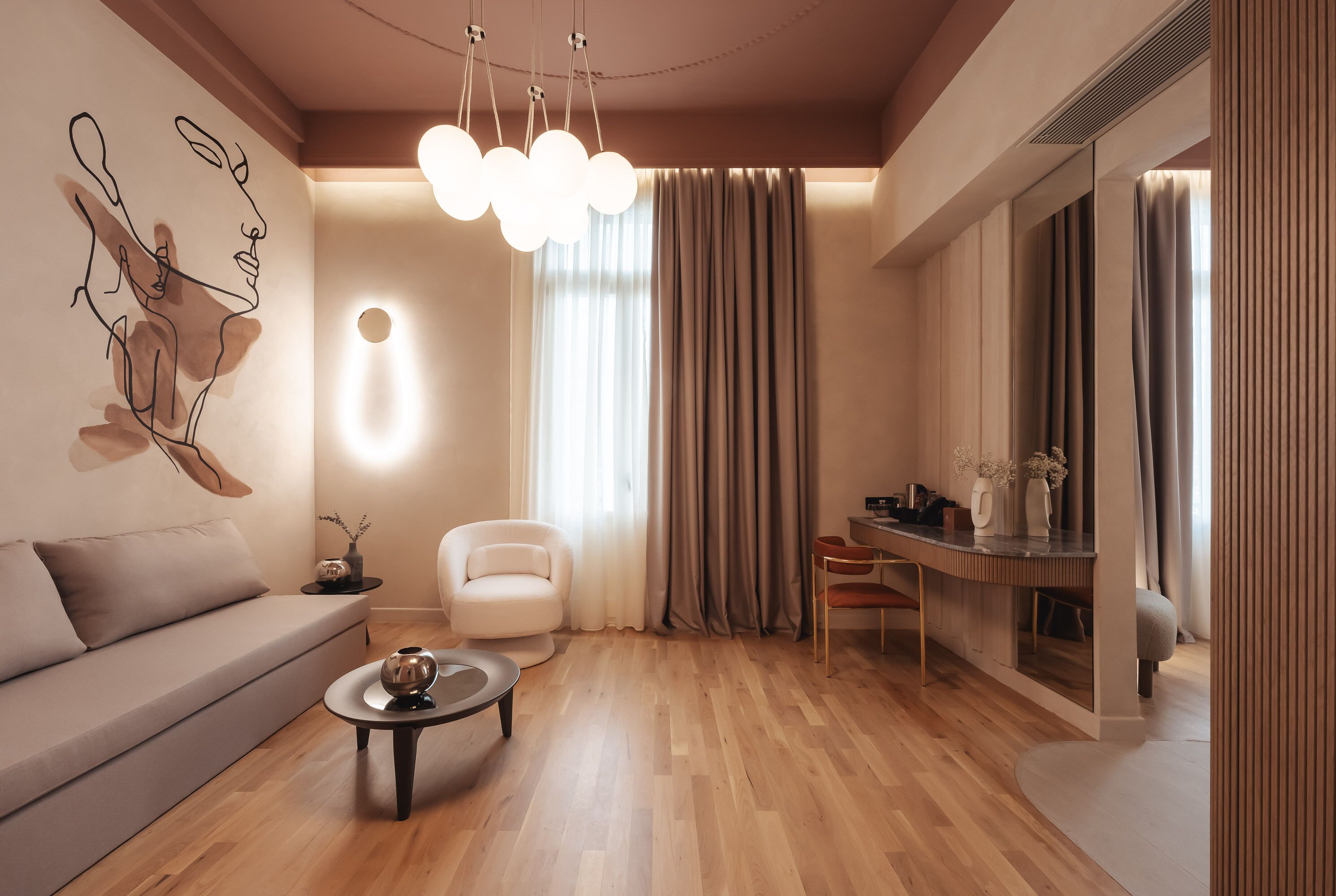 A modern living room with a sofa, a coffee table, a chair, and a dining area with a table and chairs.