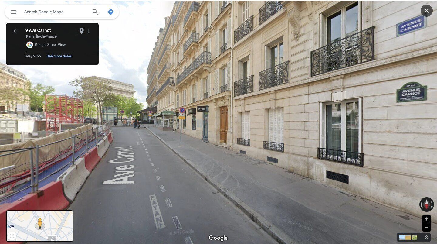 A street view of Avenue Carnot in Paris, with buildings on either side and a clear road.