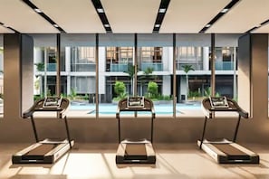 A modern gym with three treadmills aligned in front of large windows overlooking a pool and greenery. - Luxurious 1BR Suite Signature Livings in Dubai (Dubai)