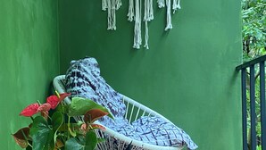 A green wall with macrame decorations, a chair, and a Buddha statue. - Jungle luxury on a budget,, brand new space (Puerto Carrillo)