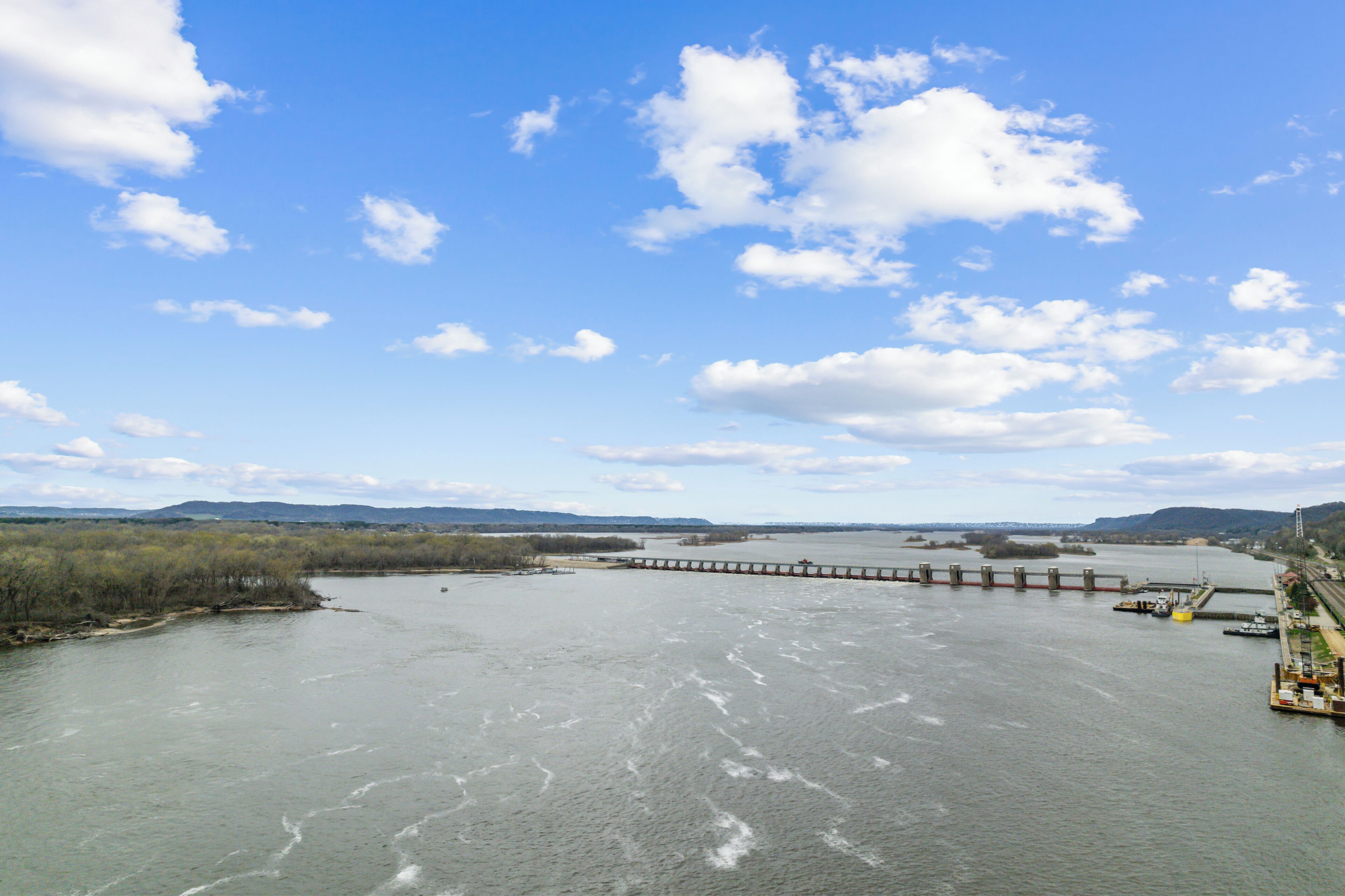 A river with a bridge and a dock.