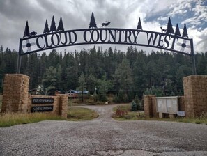Señal de propiedad privada con un aviso de 'No Entrar' y un letrero de 'Cloud Country West' encima.