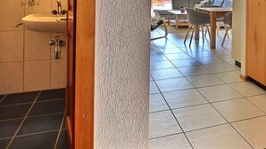A narrow hallway with a sink, wooden cabinets, and a tiled floor. - Very comfortable flat for 5 people, living room with fireplace, kitchen area with dishwasher, 1 2-be (Grimentz)
