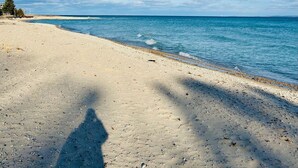 Ein Strand mit blauem Himmel und ruhiger See.