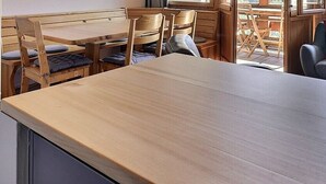 A wooden dining table with chairs, a bench, and a sofa with decorative pillows. - Comfortable flat on 2 levels for 6 people, living room, kitchen area with dishwasher, 1 double bedro (Grimentz)