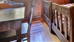 A wooden cabin-style room with a bed, a small table, and a window. - Comfortable traditional chalet on 2 levels for 7 to 8 people, living room, separated kitchen with di (Grimentz)