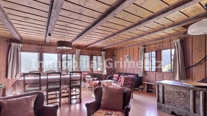 A rustic wooden interior with a dining table, chairs, and a sofa. - Comfortable traditional chalet on 2 levels for 7 to 8 people, living room, separated kitchen with di (Grimentz)
