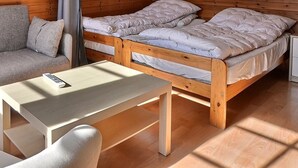 A cozy room with a wooden bunk bed, a sofa, and a small table. - Comfortable studio for 2 people, living room with 2 beds, kitchen area with dishwasher, shower-WC, s (Grimentz)