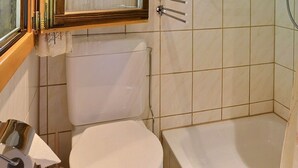 A bathroom with a toilet, a sink, and a shower area. - Comfortable flat on 2 levels for 3 to 4 people, living room, kitchen area, 1 double bedroom (140), 1 (Grimentz)