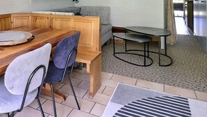 A wooden dining table with two chairs, a round tray, and a small round table with a stool. - Middle class flat for 4 people, small living room with fireplace, kitchen area with dishwasher, 1 sm (Grimentz)