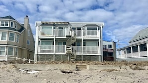 A beachfront multi-story building with balconies and a spiral staircase. - Oceanfront Wells Beach Condo - Ocean Surf #5 (Wells)