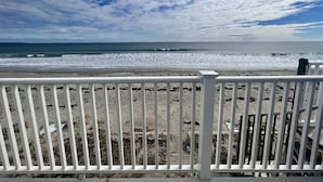 A beach with a white fence in the foreground and a view of the ocean. - Oceanfront Wells Beach Condo - Ocean Surf #5 (Wells)