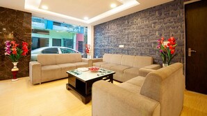 A modern living room with two sofas, a coffee table, and decorative vases.
