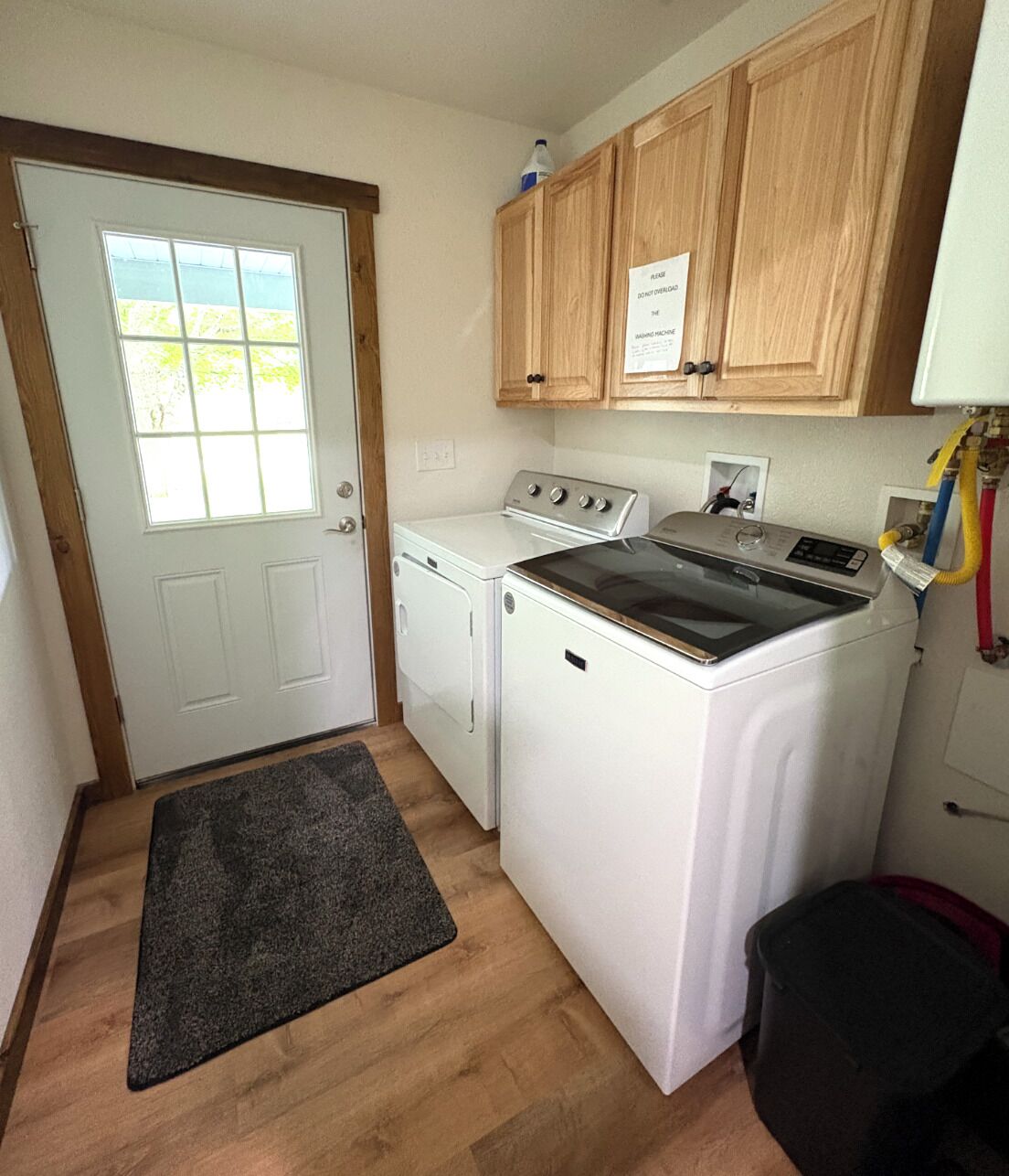 A laundry room with a washing machine, dryer, and a stove.