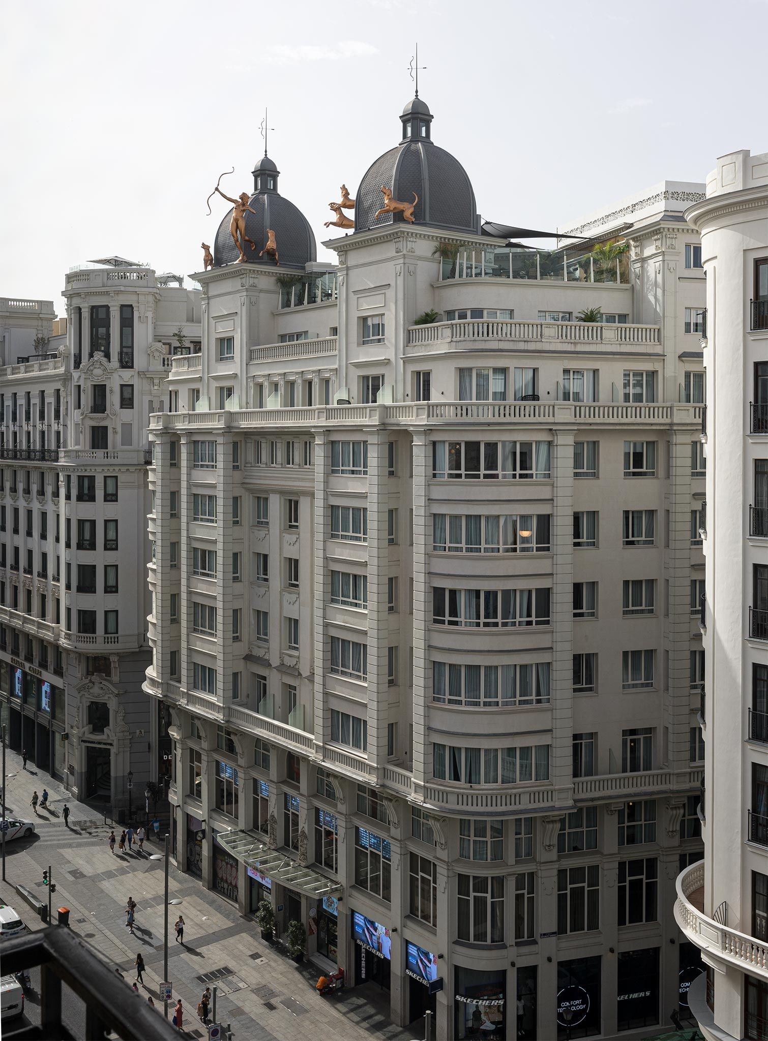 A multi-story building with classical architecture, featuring balconies and large windows.