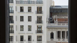 A multi-story building with balconies and large windows. - Live It Gran Via (Madrid)