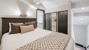 A modern hotel room with a large bed, a ceiling fan, and built-in wardrobes. - Lodge at Lionshead 330 (Vail)