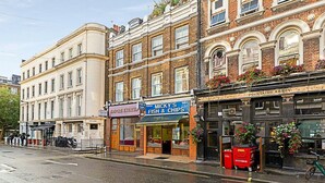 A street view with a row of shops including 'Micky's Fish & Chips' and 'Fountains Abbey Pub'.