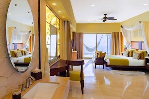Relax in a spacious room with a comfortable bed, seating area, and large window.