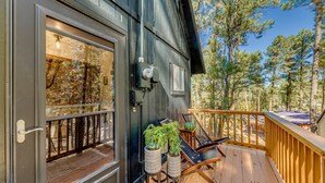 A wooden deck with outdoor seating, a door with glass panels, and potted plants. - Ruidoso Rental w/ Private Hot Tub: Walk to Midtown (Ruidoso)