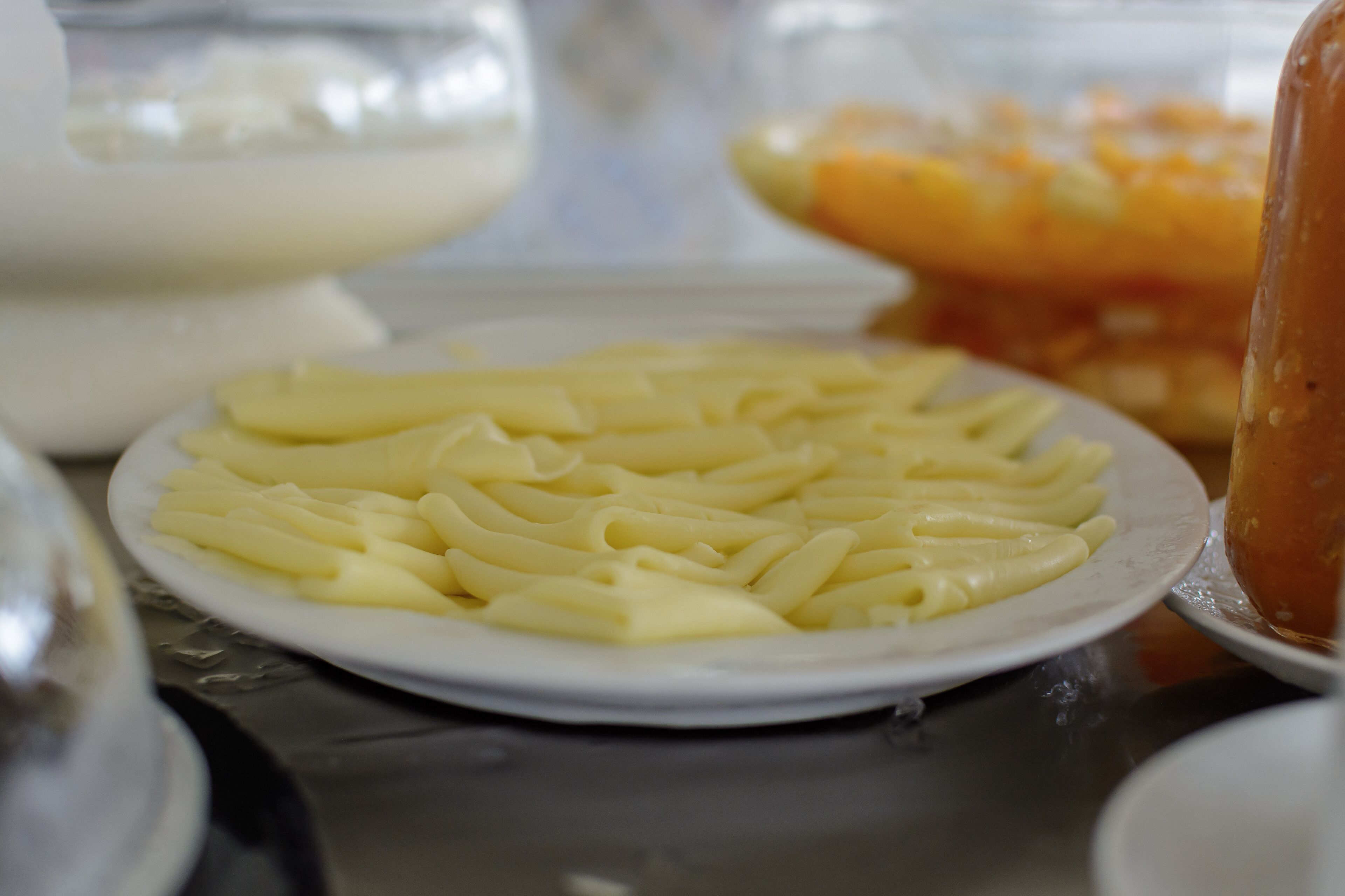 A plate of pasta on a table with other dishes in the background.