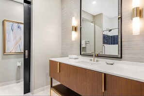 A modern bathroom with a large mirror, a sink, and a shower area. - 2Bed/2Bath Gorgeous New Resort in Downtown Atlanta!! (Atlanta)