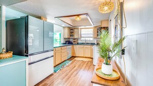 A modern kitchen with wooden cabinets, a black refrigerator, and a wooden countertop. - Private Pool & Dock: Old Florida Waterfront Home (Hernando Beach)
