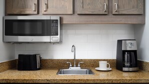 A kitchen with a microwave, toaster, coffee maker, and a sink. - Beautiful Marriott Ocean Point Resort - Studio Villa - on the beach. (Palm Beach Shores)