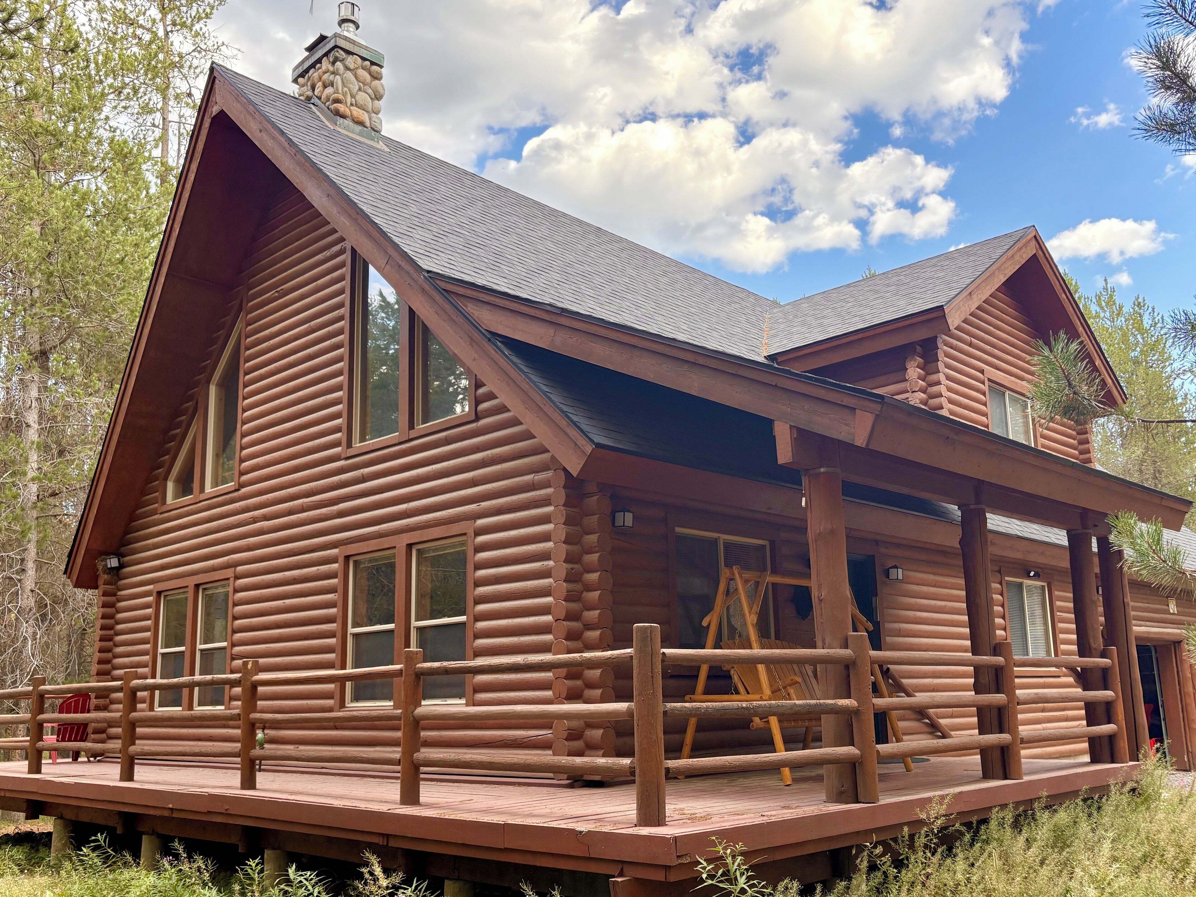 This rustic two story cabin with wraparound deck is your home away from home!