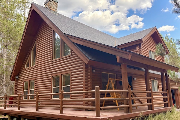 This rustic two story cabin with wraparound deck is your home away from home!