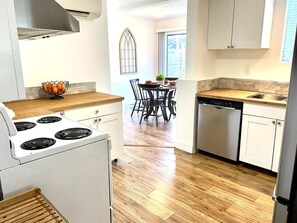 Fridge, stovetop, cookware/dishes/utensils, dining tables