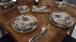 A dining table set with plates, cutlery, a wine bottle, and glasses. - AT - La higuera, Deluxe by VGH (Jerez de la Frontera)