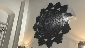 A bedroom with a bed, two pillows, a decorative wall piece, and two wall-mounted lamps. - AT - La higuera, Deluxe by VGH (Jerez de la Frontera)