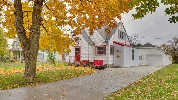 A two-story house with a red front door, a garage, and a driveway. - Harmony Home w/ Fire Pit: 5 Mi to Niagara Cave! (Harmony)