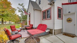 A patio with outdoor furniture, a fire pit, and a door with a 'hello' sign. - Harmony Home w/ Fire Pit: 5 Mi to Niagara Cave! (Harmony)