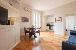 Um apartamento moderno com sala de jantar, cozinha e sala de estar.
