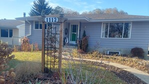A residential house with a front porch, a mailbox, and a number sign. - 1 bedroom basement suite, private entrance, safe,quiet ,tree lined neighborhood. (Sherwood Park)