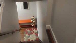 A staircase with wooden steps leading to a landing. - 1 bedroom basement suite, private entrance, safe,quiet ,tree lined neighborhood. (Sherwood Park)