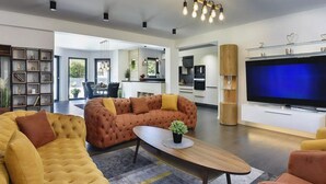 A modern living room with a sofa, a coffee table, and a TV. - Beautiful home in Pula (Pula)