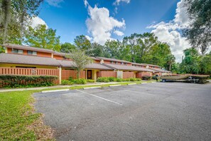 Simple motel-style accommodations line a quiet suburban street.